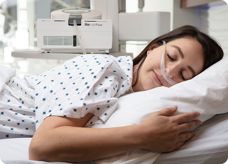 Masimo - woman on stomach in hospital bed with TNI softFlow